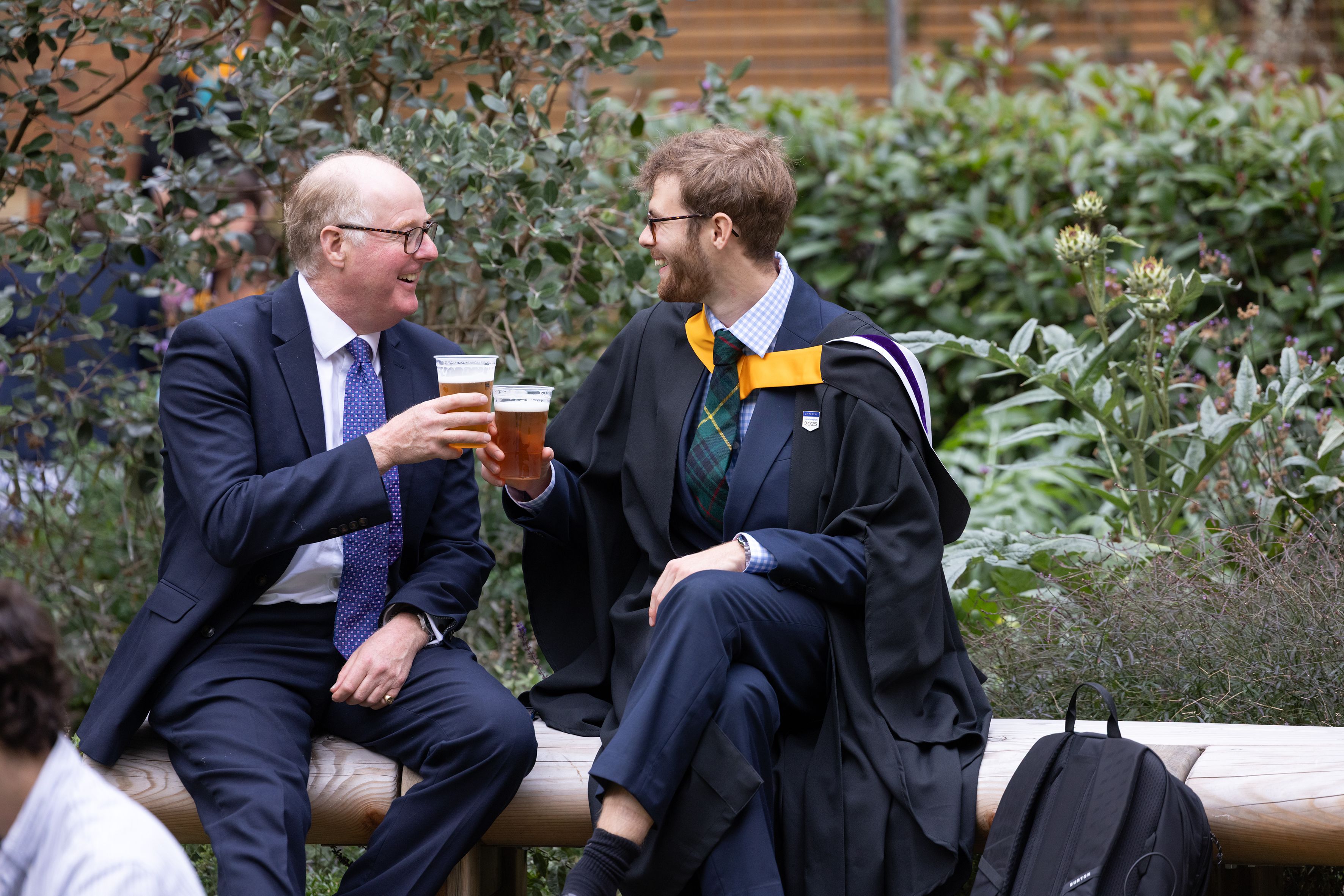 Graduate toasts a drink with their guest