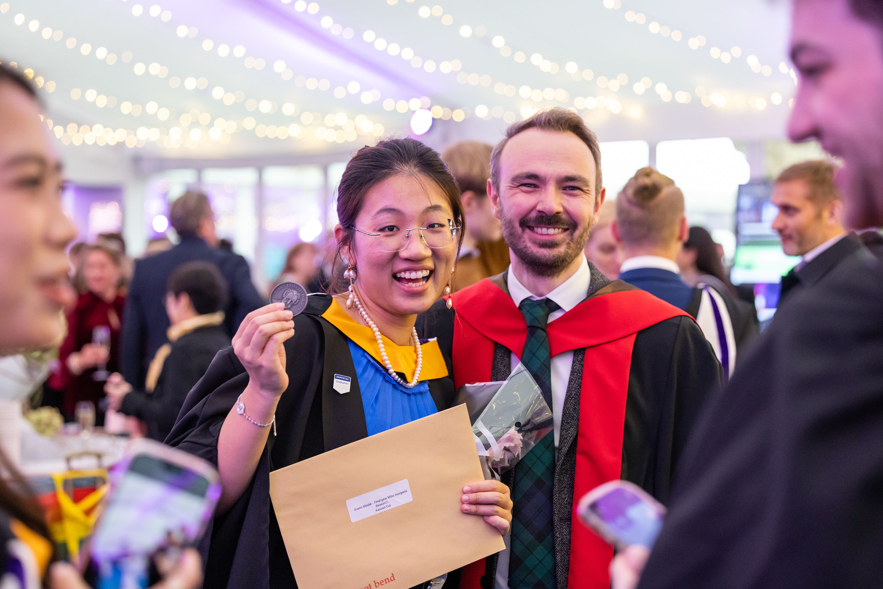 Two graduates in the reception area