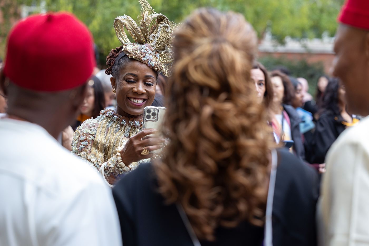 A guest takes a photo of a graduate