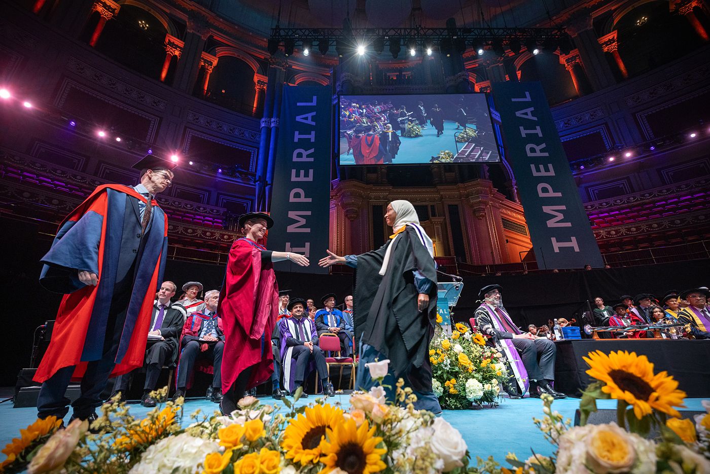 A graduand crosses the stage