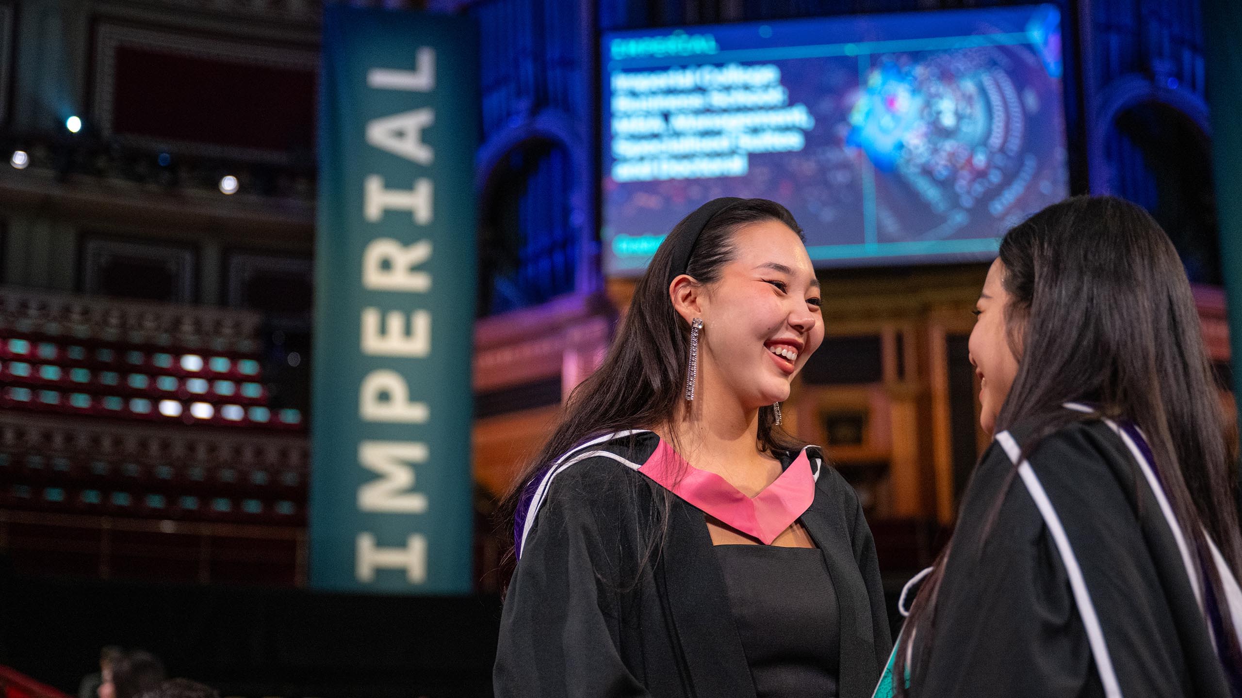 Business School graduate in pink collar