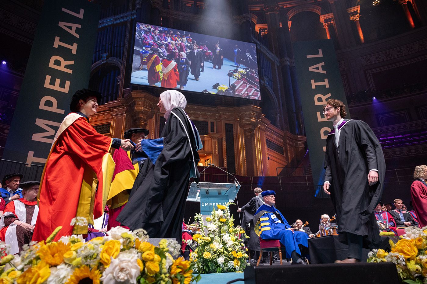 Graduands crossing the stage
