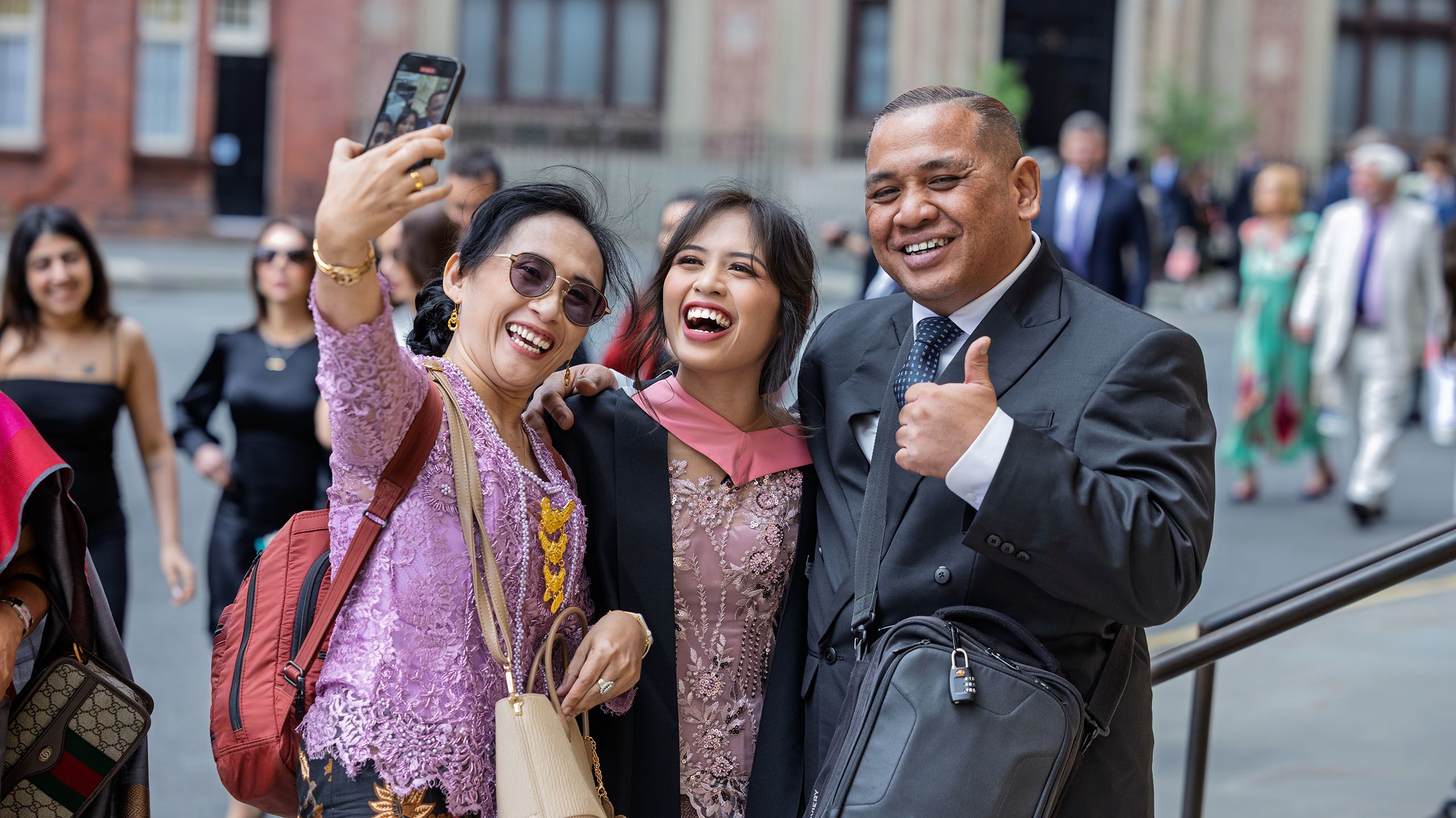 A Business School graduate and guests take a selfie