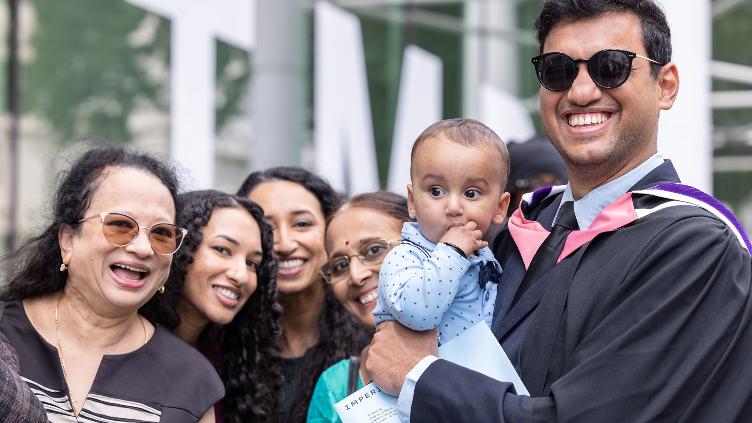 Business School graduate with family pose for a photo