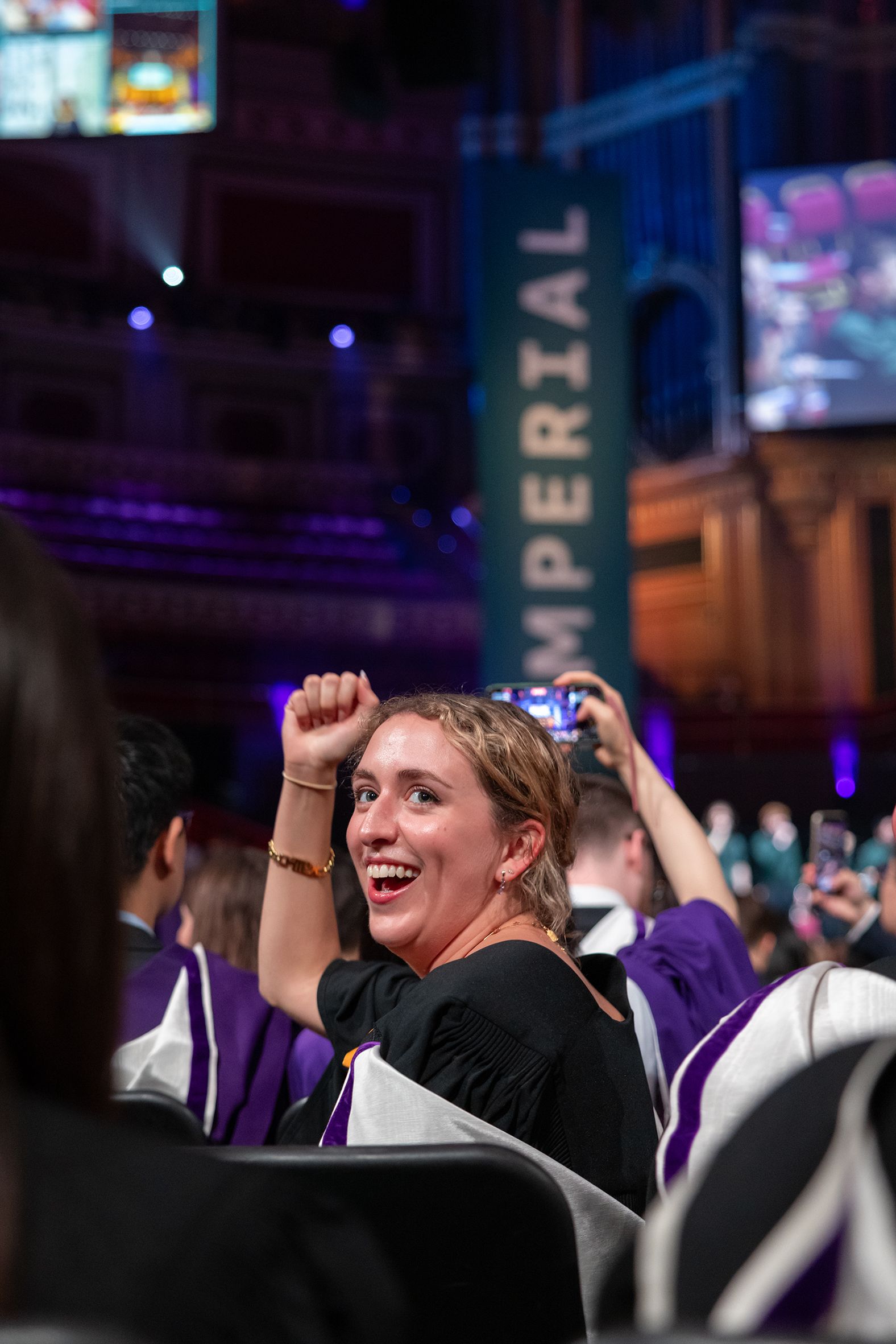 A graduate cheering